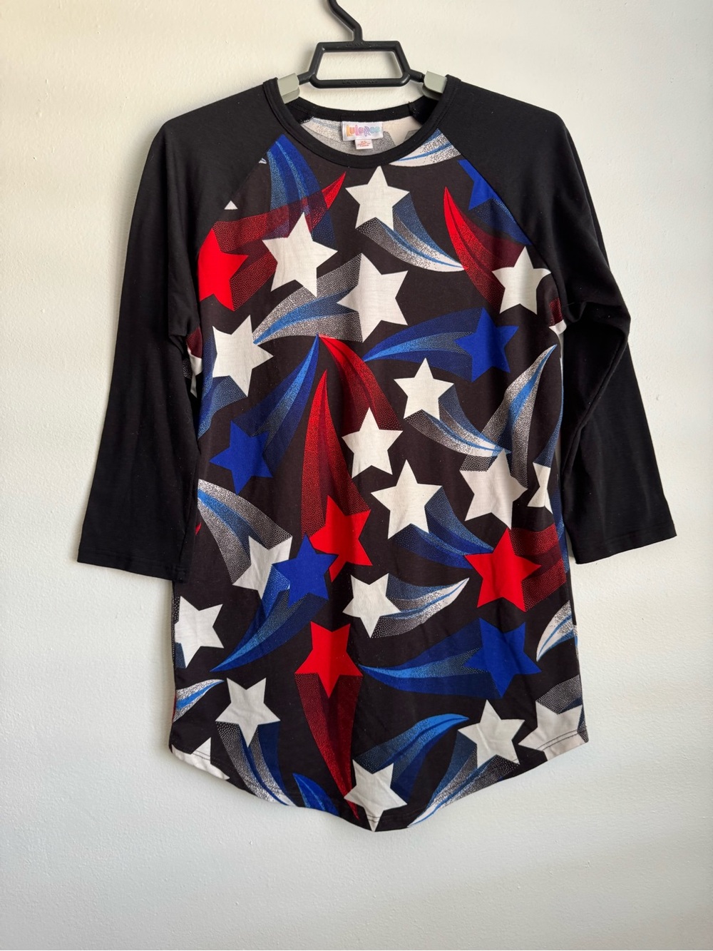 LuLaRoe Black Raglan Top with Red, Blue, White Starburst Print